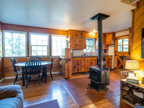 A-frame cabin dining area with a wood stove