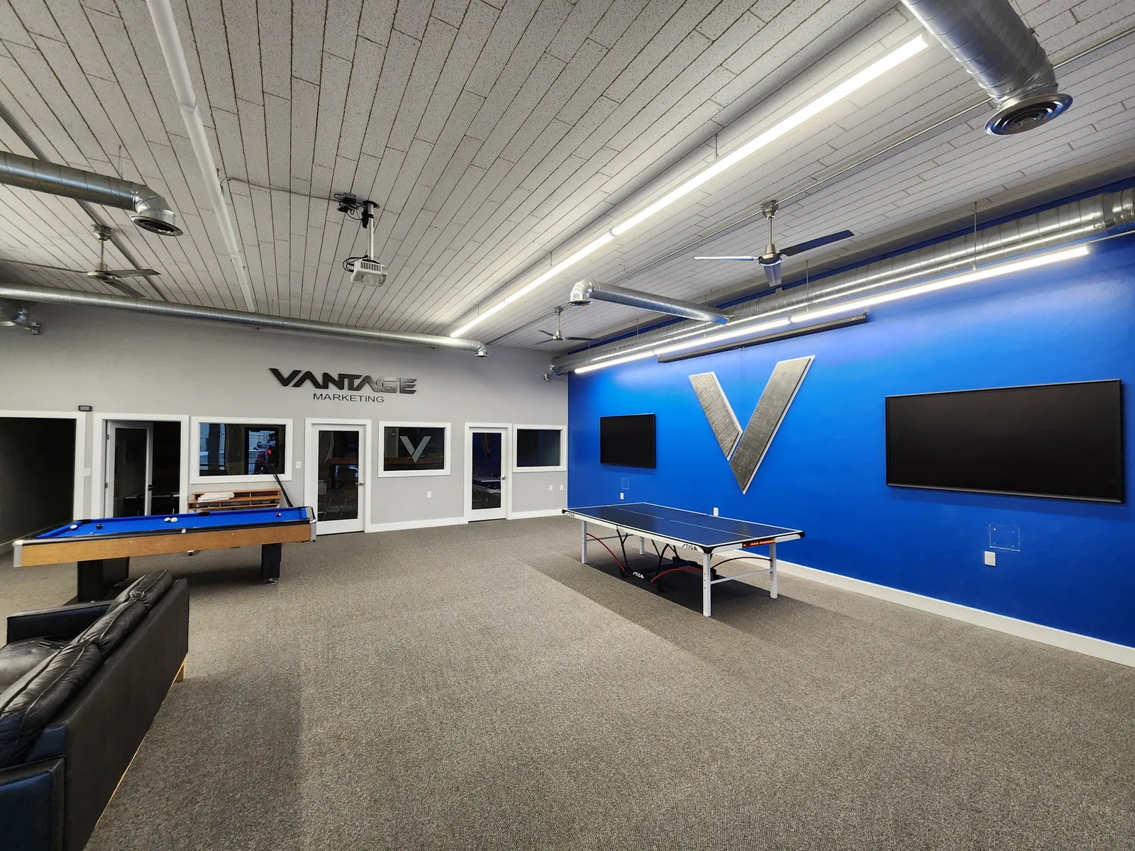 Finished commercial game room with a pool table and ping-pong table