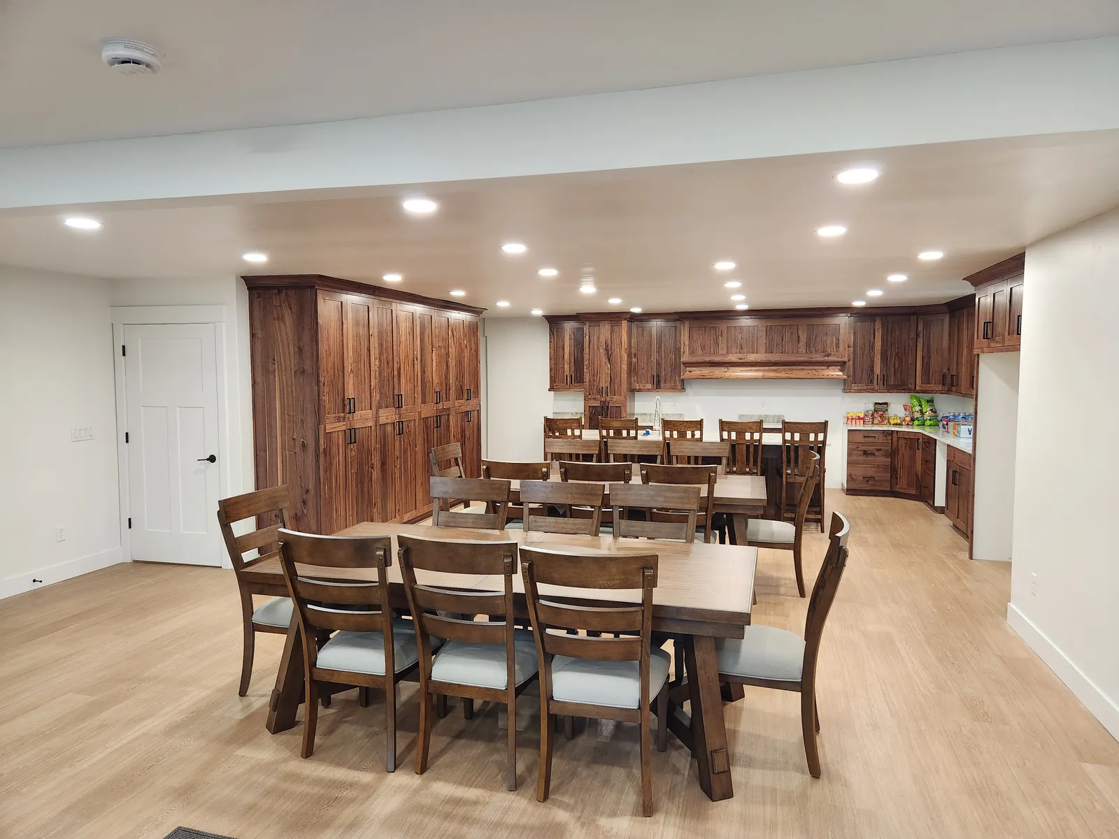 Great room with dining tables and wood cabinetry